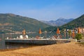 Summer beach vacation. Beautiful Mediterranean landscape with beach umbrellas on sunny summer day. Montenegro, Kotor Bay Royalty Free Stock Photo