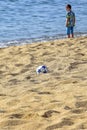 Summer beach vacation. Soccer ball lies on sand