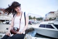 Summer beach woman fun holding vintage retro camera laughing and smiling happy during summer holiday vacation travel Royalty Free Stock Photo