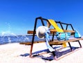 Summer beach women beachwear  on wooden bench  hat with blue bow sunglasses and hand bag and yellow towel  accessory, on horizon s Royalty Free Stock Photo