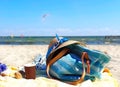 Holiday  Travel Beach Girl clothes Relaxation   Summer beach red dress hat with blue scarf and blue hand bag on sand seascape sky Royalty Free Stock Photo