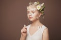 Summer beauty portrait of cute young woman with white spring flowers in her hairstyle and butterfly on her healthy skin Royalty Free Stock Photo