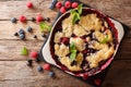 Summer berry cake with raspberry berries, currants and blueberries close-up in a baking dish. Horizontal top view Royalty Free Stock Photo