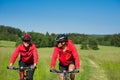 Summer bike - Young sportive couple in meadow