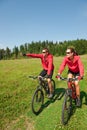 Summer bike - Young sportive couple in meadow