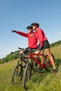 Summer bike - Young sportive couple in meadow