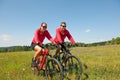 Summer bike - Young sportive couple in meadow Royalty Free Stock Photo