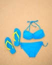 Summer bikini and accessories stylish beach set, Beach bikini summer outfit and sea sand as background, Top View, Concept Royalty Free Stock Photo