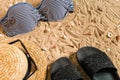 Summer bikini and accessories stylish beach set, Beach bikini summer outfit and sea sand as background, Top View Royalty Free Stock Photo