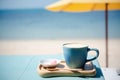 Summer blue coffee Latte cup by the beach with yellow umbrella background