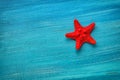 Summer board of red star fish on blue wooden background Royalty Free Stock Photo