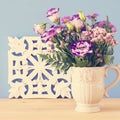 summer bouquet of purple flowers in the vase over wooden table and blue background. Royalty Free Stock Photo