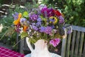 summer bouquet in vase in garden setting