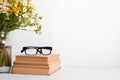 Summer bouquet of wildflowers in glass vase, old books on rustic background. Season design concept. Teachers day concept, back to Royalty Free Stock Photo