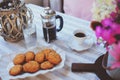 Summer breakfast in cozy country house. Table with bouquet of flowers from own garden, french press with coffee and cookies. Royalty Free Stock Photo