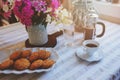 Summer breakfast in cozy country house. Table with bouquet of flowers from own garden, french press with coffee and cookies. Royalty Free Stock Photo