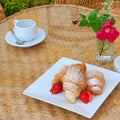 Summer breakfast: croissant, strawberry, coffee