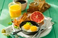 Summer breakfast - eggs, bacon, toast, jam, coffee, juice Royalty Free Stock Photo