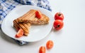 summer breakfast. toast ham cheese on a white plate in the kitchen, a beautiful serving of food, fresh cherry tomatoes. deliciou Royalty Free Stock Photo