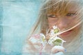 little girl smelling daisy bouquet