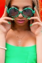 Summer bright portrait of a pretty young girl in a green fashion