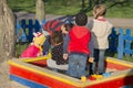 In summer, a bright and sunny day a lot of small children playing in the sandbox. Royalty Free Stock Photo