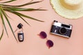 Summer bright travel flat lay with sunglasses, car keys, vintage camera and straw hat on beige background. Car travel. Top view