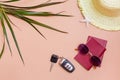 Summer bright travel flat lay with sunglasses, passports, car keys and a straw hat on a beige background. Car travel. Top view