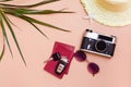 Summer bright travel flat lay with sunglasses, passports, car keys, vintage camera and straw hat on a beige background. Car travel
