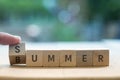 SUMMER BUMMER concept on wood blocks as finger changes S to B Royalty Free Stock Photo