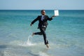 Summer business. Freelancer run on summer sea beach. Businessman in wet suit jump in sea water. Crazy business summer Royalty Free Stock Photo