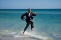 Summer business. Freelancer on summer sea beach. Business man in wet suit in sea water. Crazy business vacation. Funny Royalty Free Stock Photo