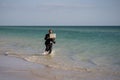 Summer business. Freelancer on summer sea beach. Business man in wet suit in sea water. Crazy business vacation. Funny Royalty Free Stock Photo