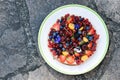 Summer cake with vanilla filling, various kinds of fruits with golden dust and decorative edible flowers