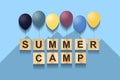 Summer Camp. Concept with words on wooden cubes and inflatable balls. Blue background. Royalty Free Stock Photo