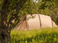 Summer camping - tourist tent in green forest Royalty Free Stock Photo