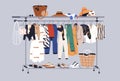 Summer capsule wardrobe with women casual clothes on hanger rail. Fashion garments, shoes and accessories on rack and