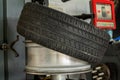 Summer car tire half taken from the disk to perform tire mounting and fitting on a special machine in the workshop for repairing Royalty Free Stock Photo