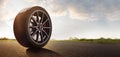 Car tires on a summer road Royalty Free Stock Photo