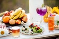 Summer catering buffet with canap snacks with eggplant, olives, herbs, tomatoes and meat. With cocktails and fruits Royalty Free Stock Photo