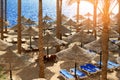 Summer chaise lounges under an umbrella on sandy sea beach in hotel Egypt, Sharm el Sheikh, concept time to travel Royalty Free Stock Photo