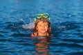 Summer child. Funny child on beach. Boy swim in sea on summer holidays. Happy kids swimming in the water. Little boy Royalty Free Stock Photo