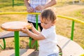 Summer, childhood, leisure and family concept - happy child and his father on children playground climbing frame Royalty Free Stock Photo