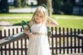 Summer, childhood, leisure, gesture and people concept - happy little girl playing on children playground Royalty Free Stock Photo