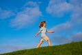 Summer, childhood, leisure and people concept. Happy little boy walking on green summer field. Kids activities on nature