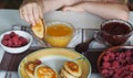 Summer children is breakfast. The child eats pancakes with honey with his hands. Baby food and allergies Royalty Free Stock Photo