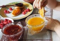 Summer children is breakfast. The child eats pancakes with honey with his hands. Baby food and allergies Royalty Free Stock Photo