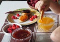 Summer children is breakfast. The child eats pancakes with honey with his hands. Baby food and allergies Royalty Free Stock Photo