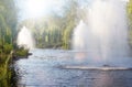 Summer city park with fresh fountains in lake. Mezhyhirya in Novi Petrivtsi, Ukraine