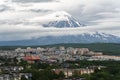 Summer city scape of Kamchatka Peninsula, residential building of Petropavlovsk-Kamchatsky City on background of active volcano
